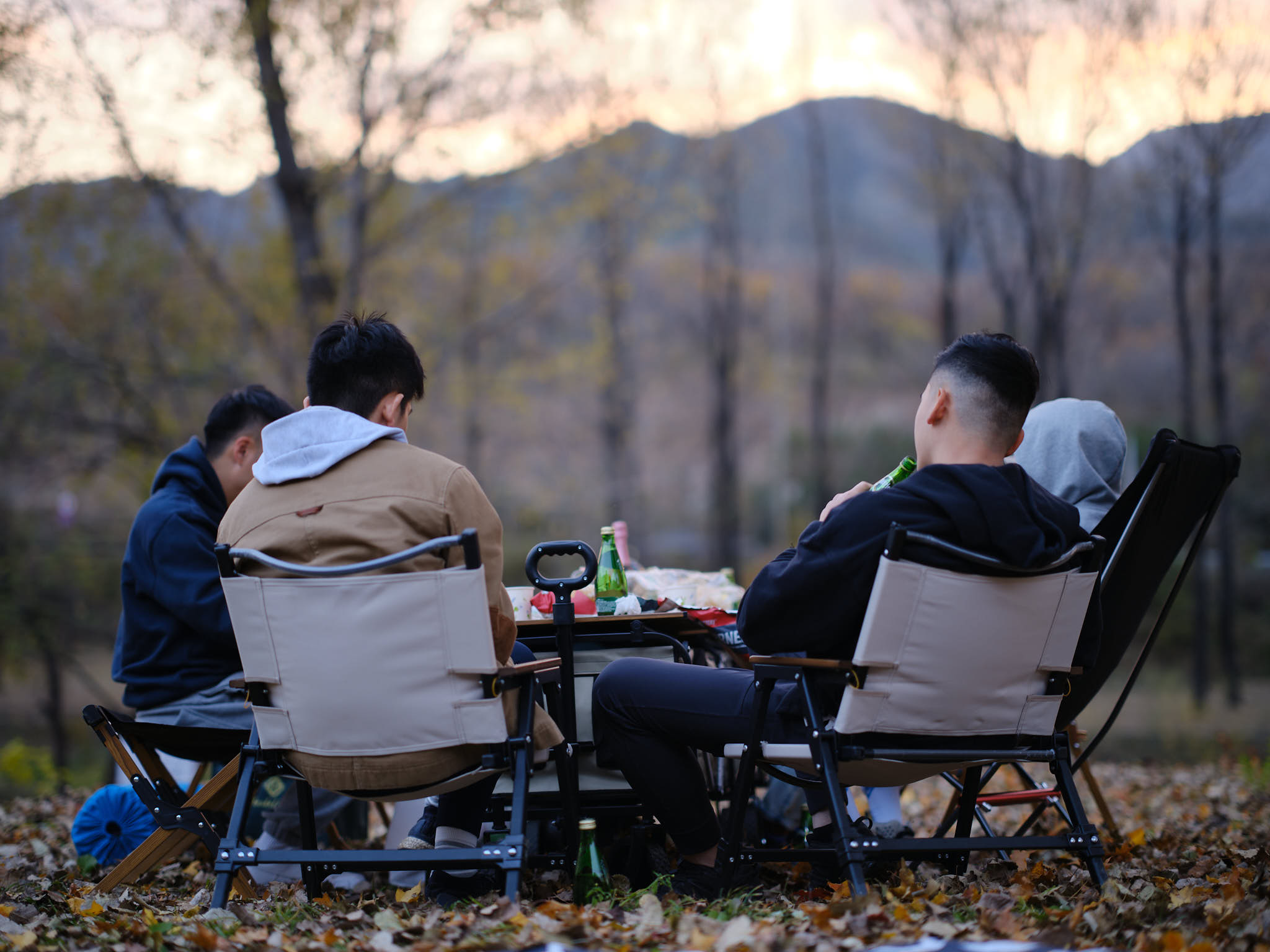 Friends sitting around day camping site in Yanqi Lake district of Beijing
