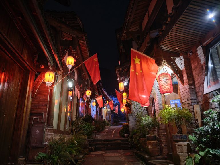 Chinese flags glow at night in Dujiangyan alley