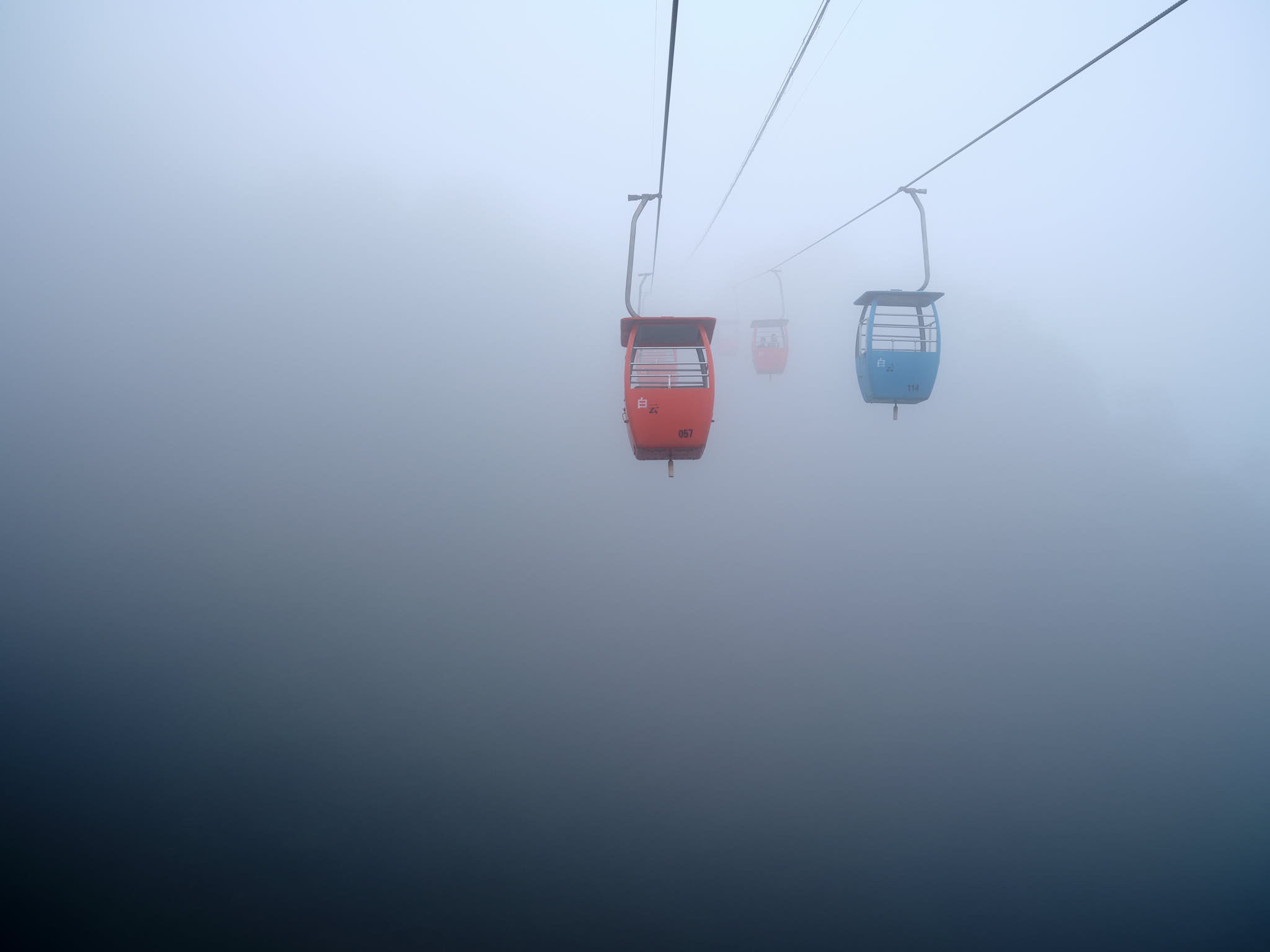 Gondola disappearing into the fog at Qingcheng Mountain