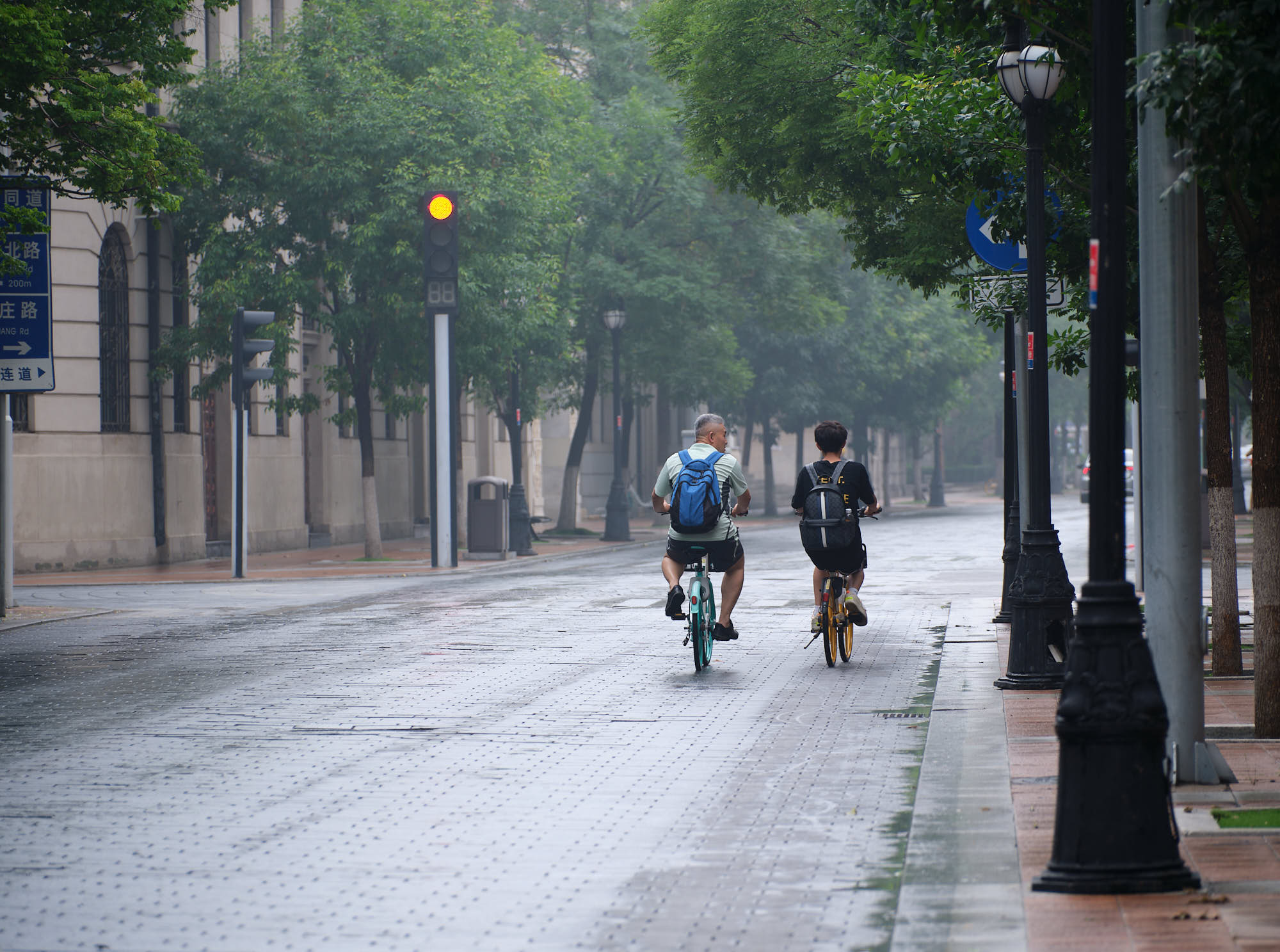 Riding bicycles in the rain in Tianjin, China