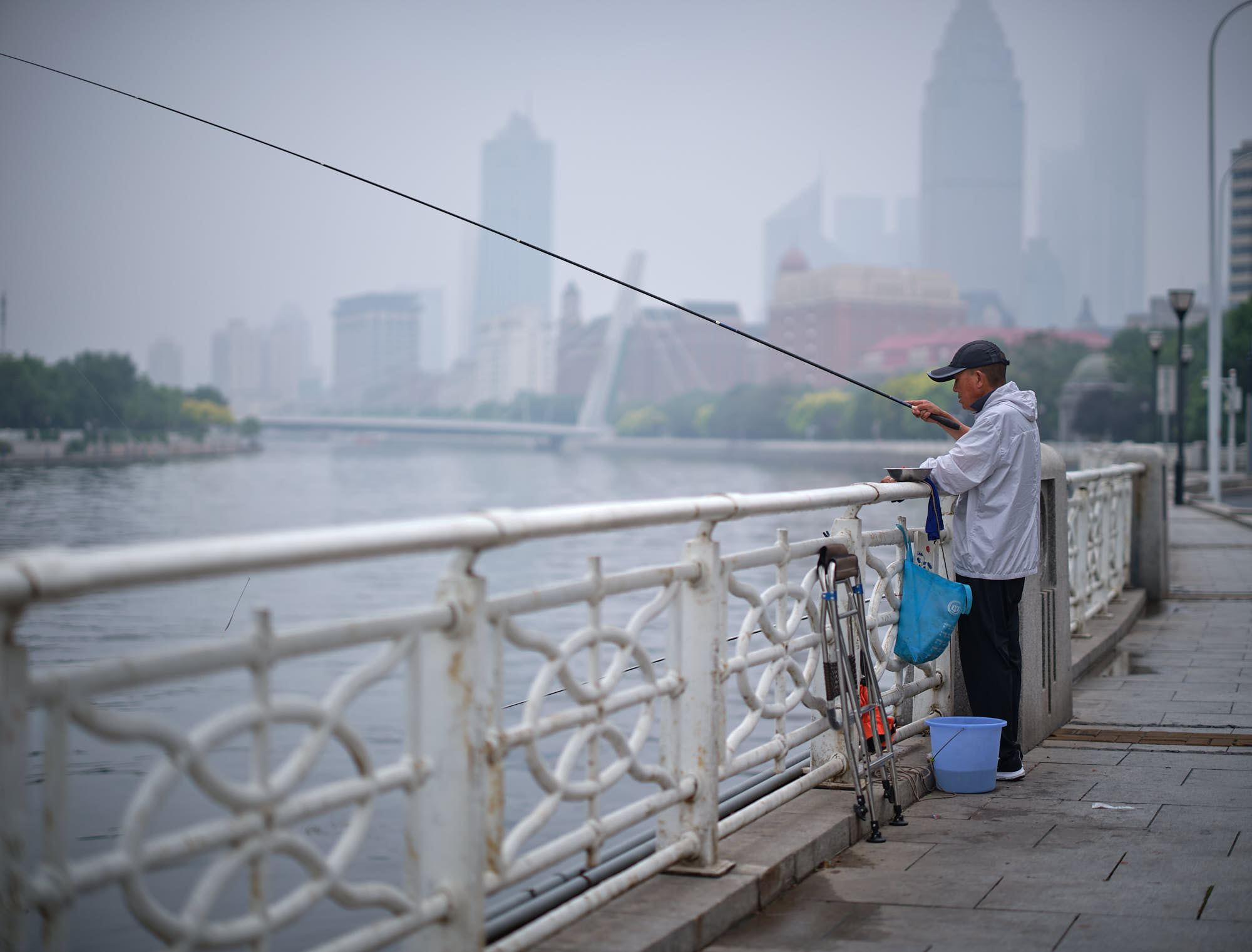 Man fishing at the river in Tianjin, China