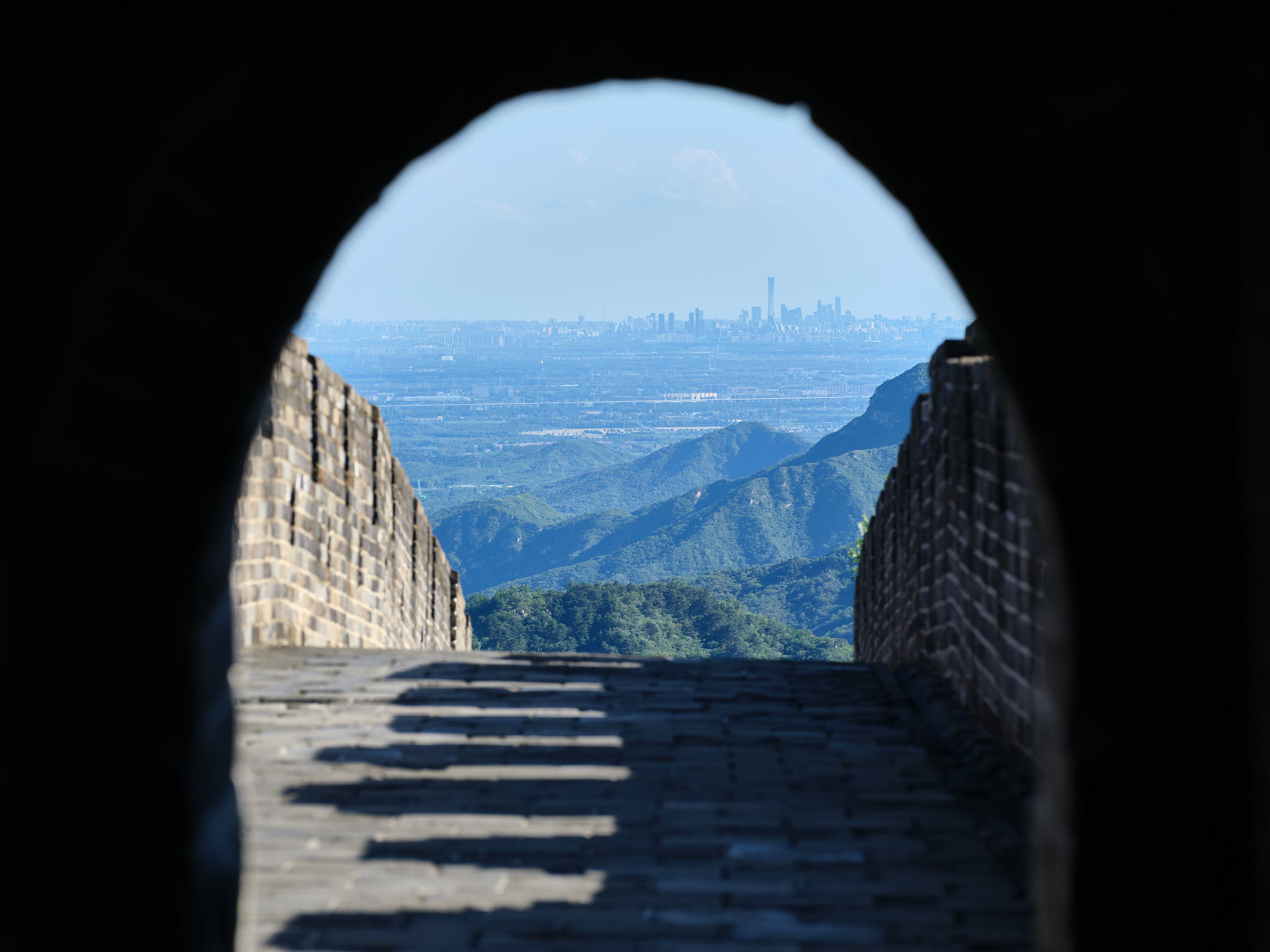View of Beijing city through a watch tower at Mutianyu section of Great Wall of China