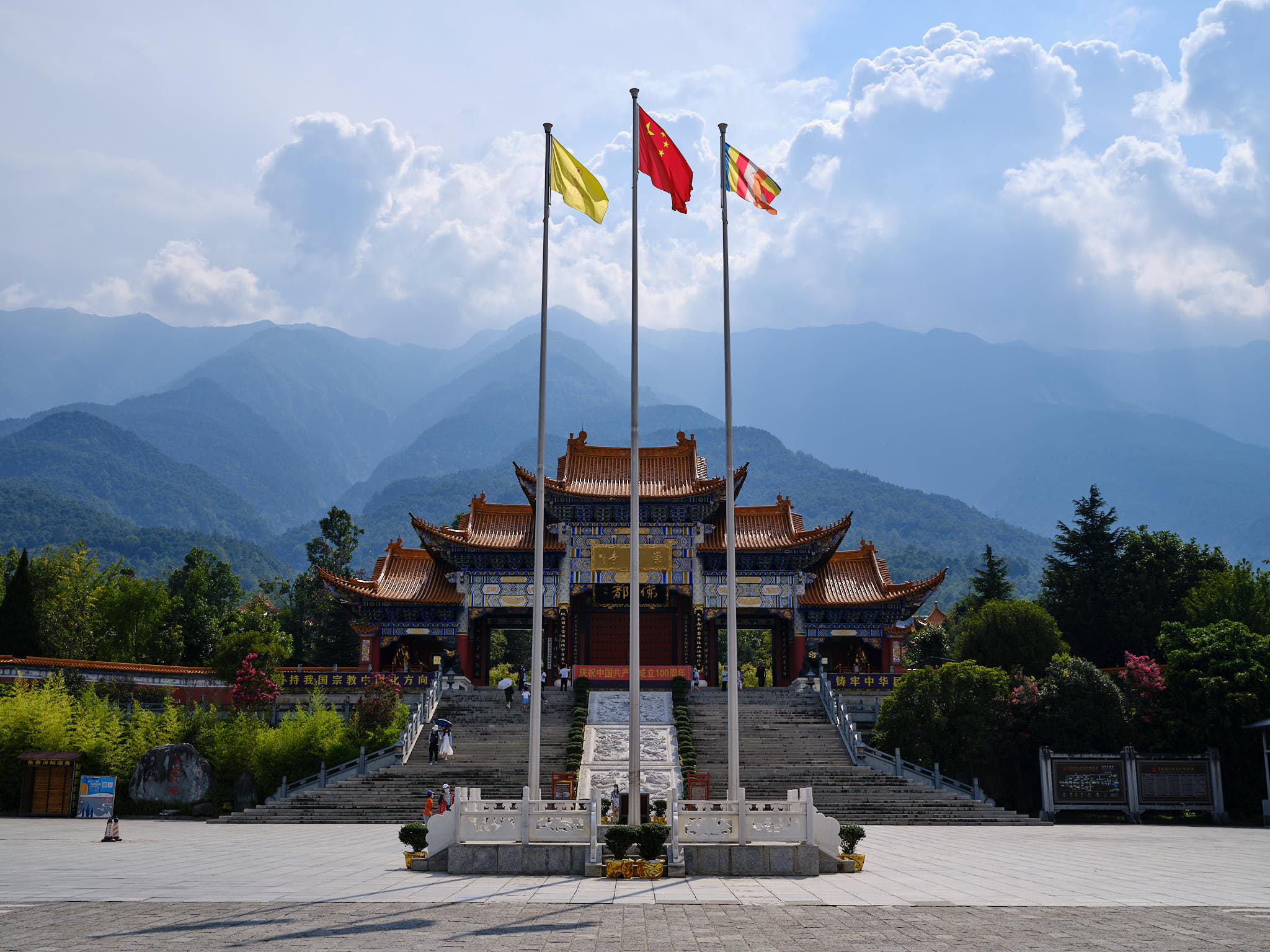 Cangshan Mountain temple with flags in the front and mountains in the back