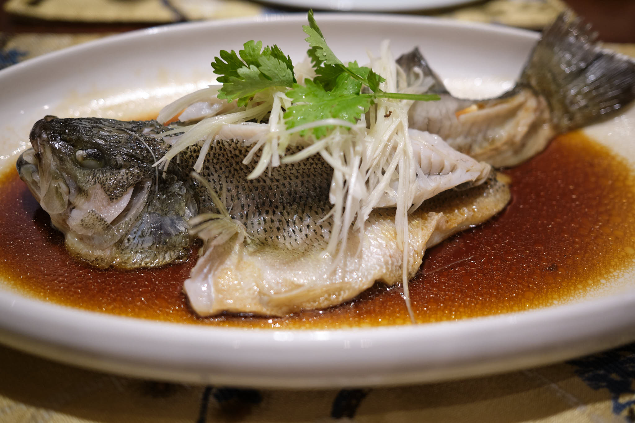 Whole fish presented on a plate at Six Senses Hotel Chengdu